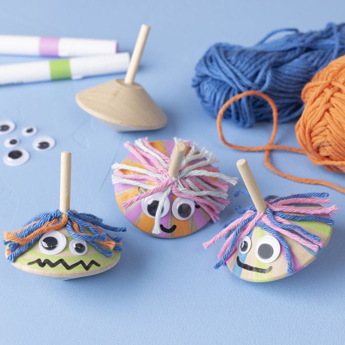 Spinning tops with googly eyes and fun hair