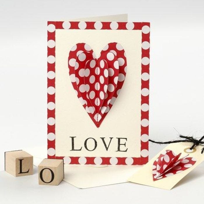 A Valentine Card with a sewn-on Paper Heart and stamped Text