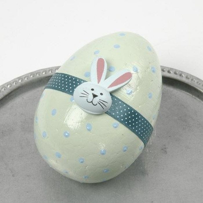 A pastel-painted Egg with a Waist Band and a wooden Sticker