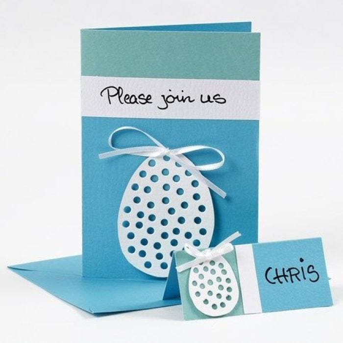 A Greeting Card with an Egg made from Card in a Satin Bow