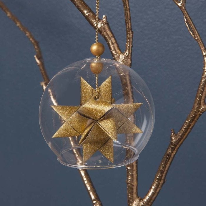 A clear Glass baseless hanging Bauble with a woven Star 