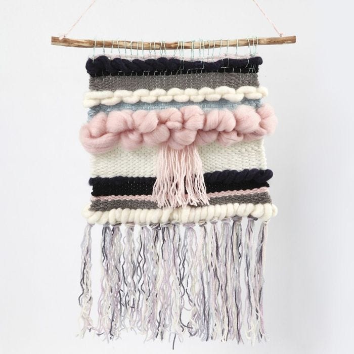 A woven Wall Hanging on a natural Stick