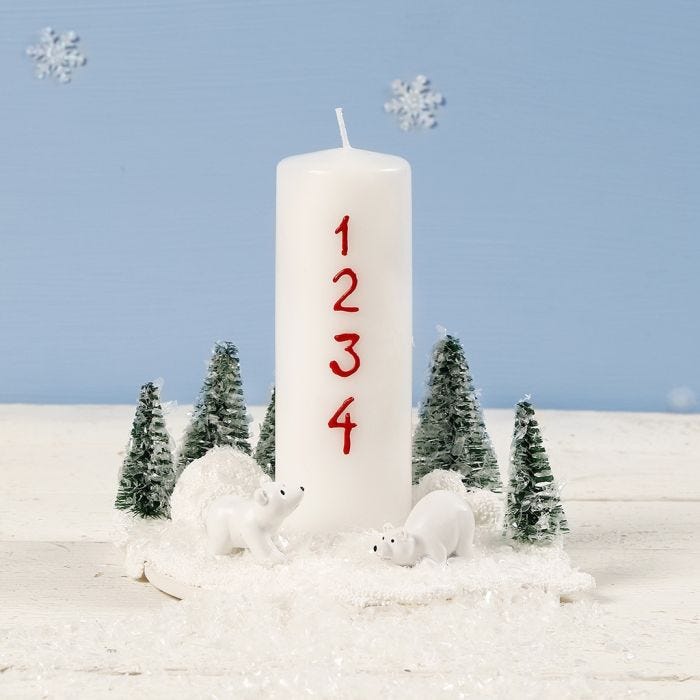 A Christmas Decoration with a Candle, miniature Polar Bears and Christmas Trees