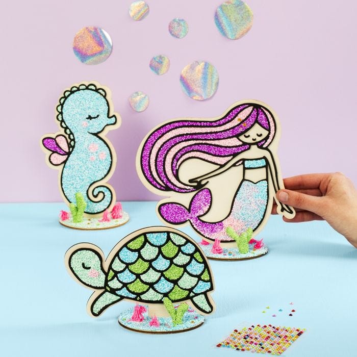 A wooden Turtle, Mermaid, and Sea Horse filled with Foam Clay