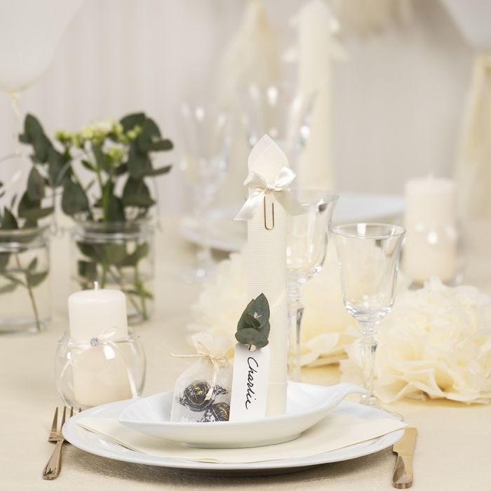 Off-white Table Decorations with Paper Flowers, Balloons, a Napkin folded like a Tower and Place Cards