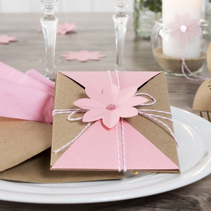 An Invitation wrapped and secured with Cotton Cord and a punched-out Flower