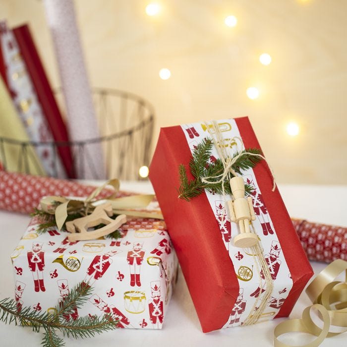 Creative Christmas Gift Wrapping with two kinds of Wrapping Paper and a wooden Figure