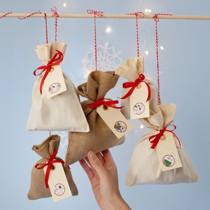 An Advent Calendar from Fabric Bags with a Numbered Sticker on Manilla Tags