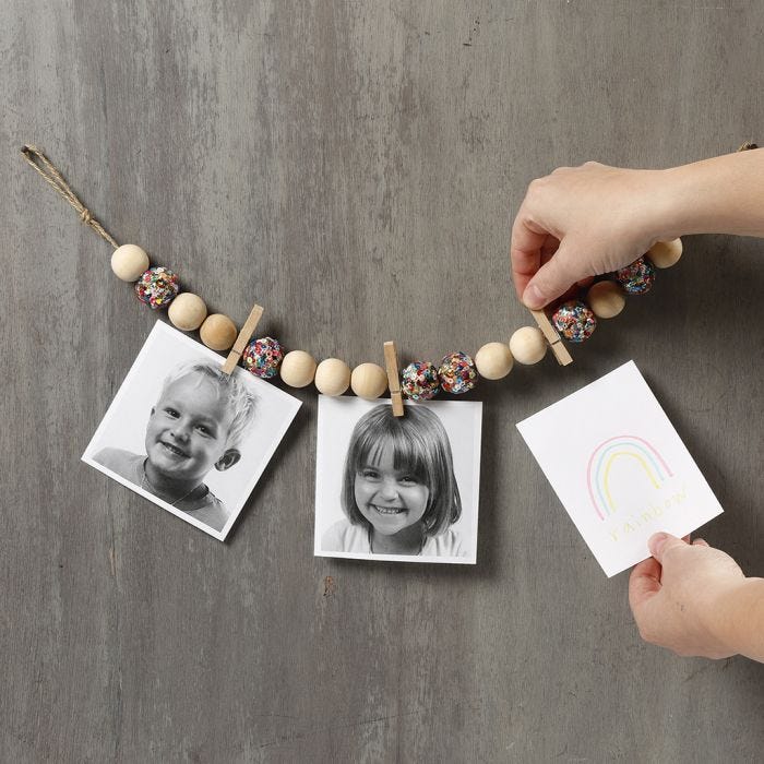 Pictures on a Piece of natural Twine with wooden Beads, Pegs and Sequins