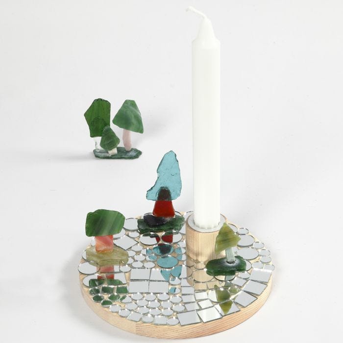 A Candlestick on a wooden Base with Mosaics