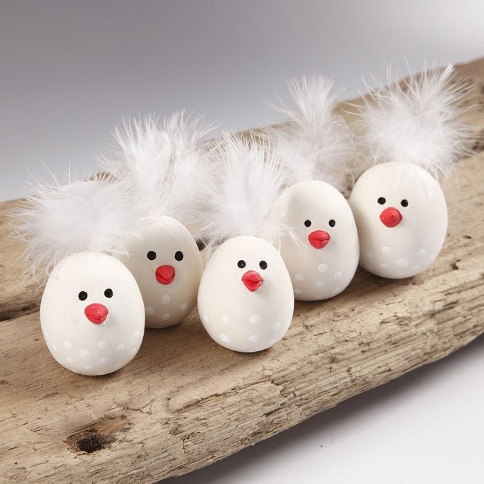 Easter chicks from self-hardening clay with a feather for the tail