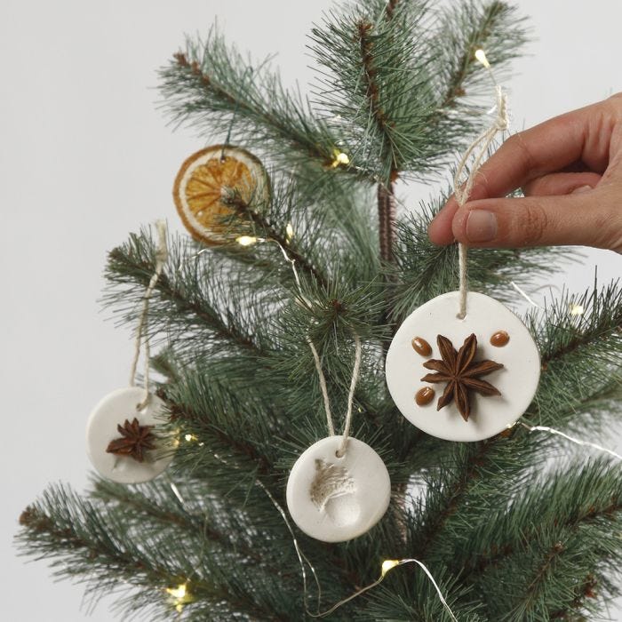 Hanging decorations made from self-hardening clay decorated with natural materials