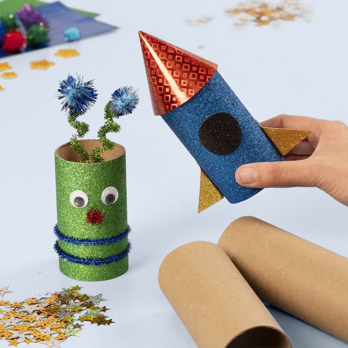 A space rocket and an alien from cardboard tubes decorated with craft materials