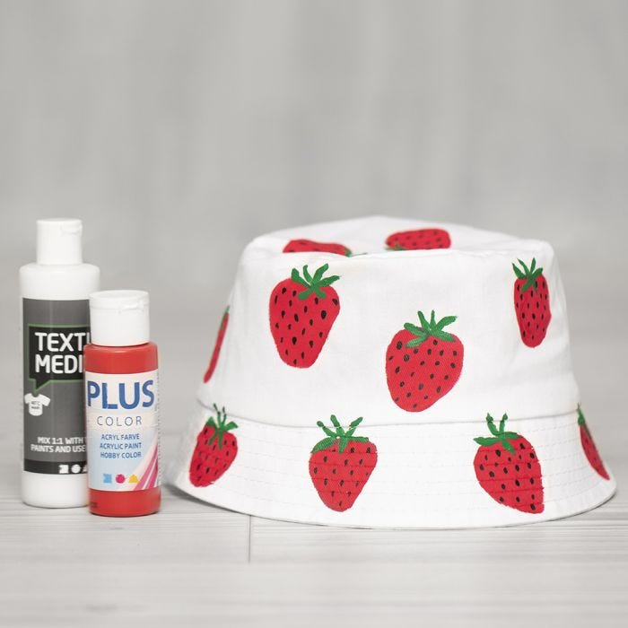 A bucket hat decorated with painted strawberries