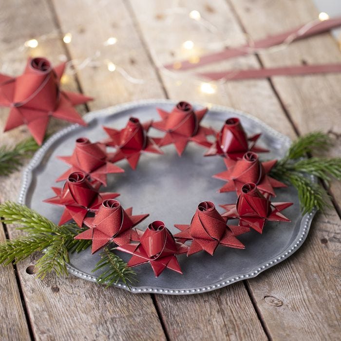 A woven Christmas star with a rose bud