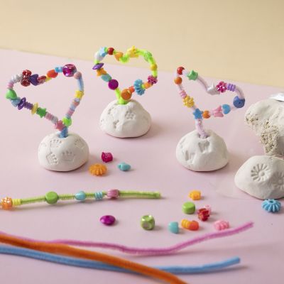 Pipe cleaner and bead heart on clay base