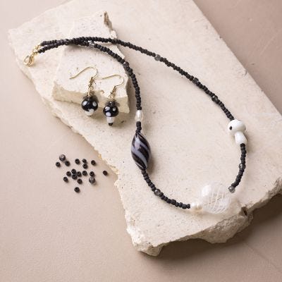 Necklace and earrings with chunky black glass beads