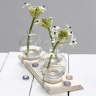 A small Vase made from a Glass Bauble standing on a Curtain Ring