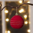 A Christmas bauble crocheted from cotton yarn