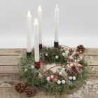 An Advent wreath decorated with natural materials and LED candles