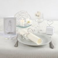 An Invitation and Table Decorations for a White Wedding