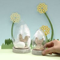 A Dome Bell Jar with self-assembly wooden Easter Figures, Eggs and white Feathers