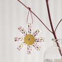 A hanging Decoration from Paper Star Strips and Glitter Paper