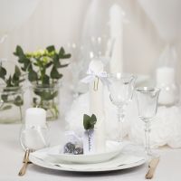 White Table Decorations with Paper Flowers, Balloons, a Napkin folded like a Tower and Place Cards