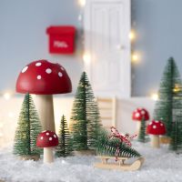 The Elf stands a Christmas Tree in front of his Elf's Door