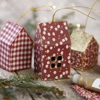 A card and fabric Christmas house decorated with glitter for hanging