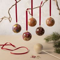 Christmas baubles decorated with dried flowers