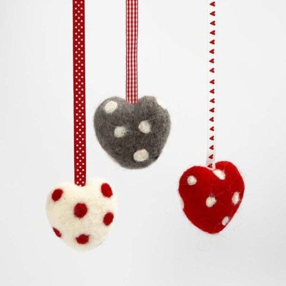 A Needle Felted Heart with Dots and a Decorative Ribbon