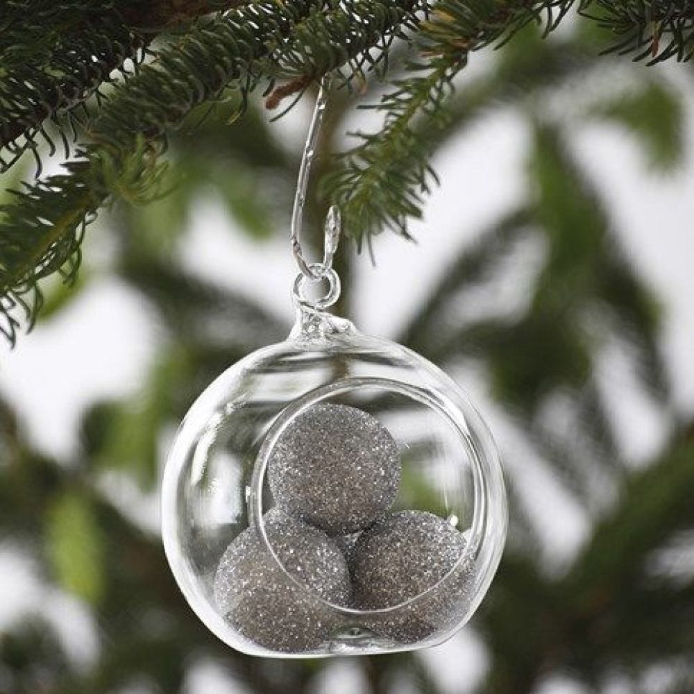 A Glass Bauble filled with silver glittering Balls