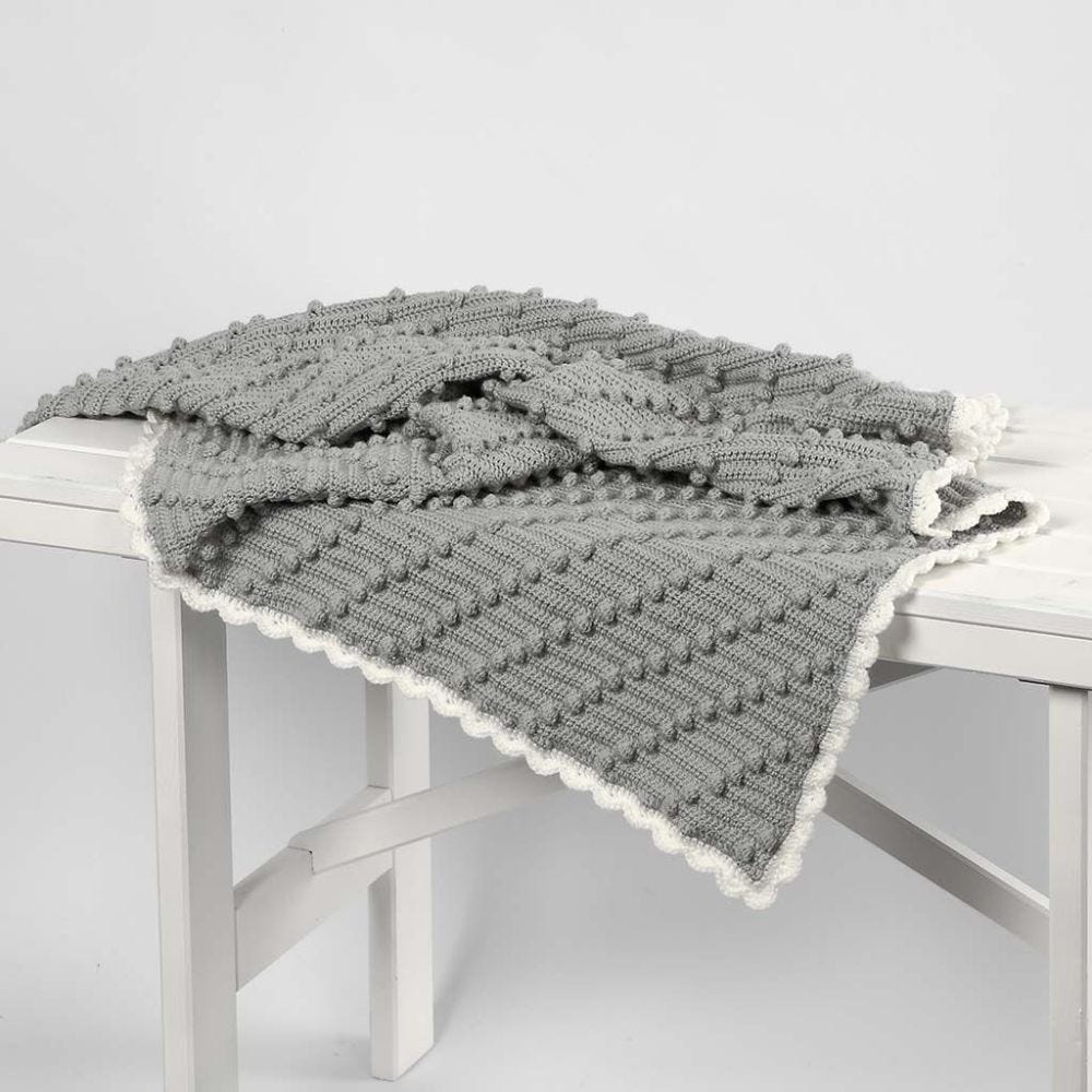 A crocheted Baby Blanket with diagonal Bobbles
