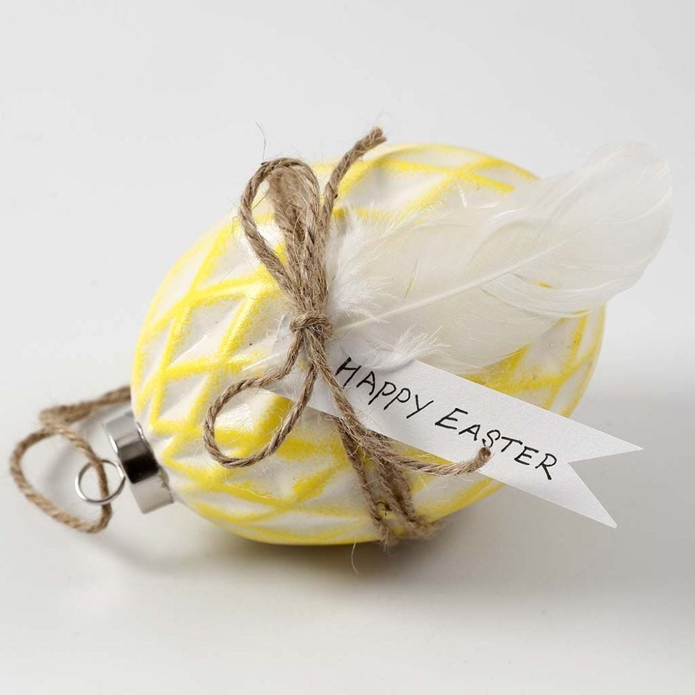 A Ceramic Egg painted and decorated with natural Twine and Feathers