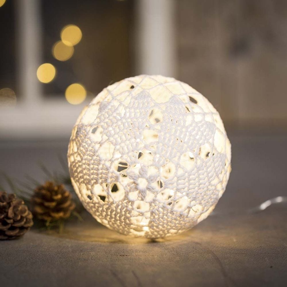 An illuminated Christmas bauble from cotton yarn