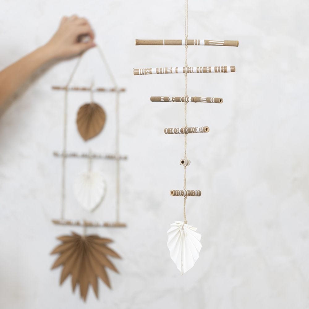 A mobile made from decorated bamboo sticks and faux leather paper
