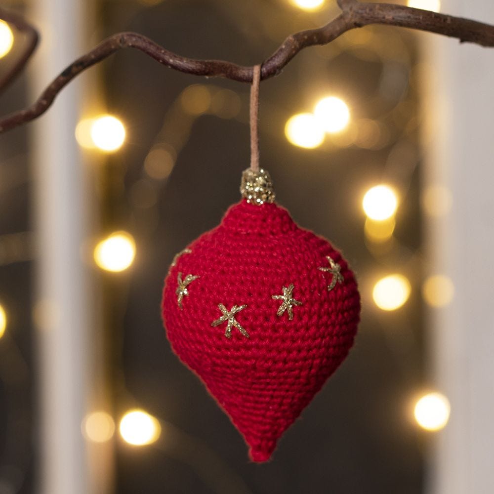 A teardrop-shaped Christmas hanging decoration crocheted from cotton yarn