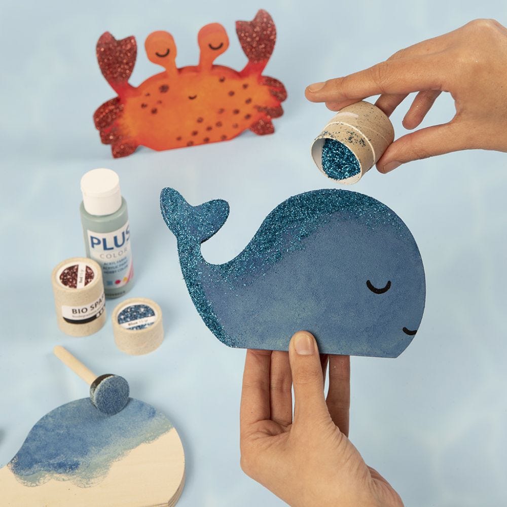 A whale and a crab decorated with craft paint and bio glitter