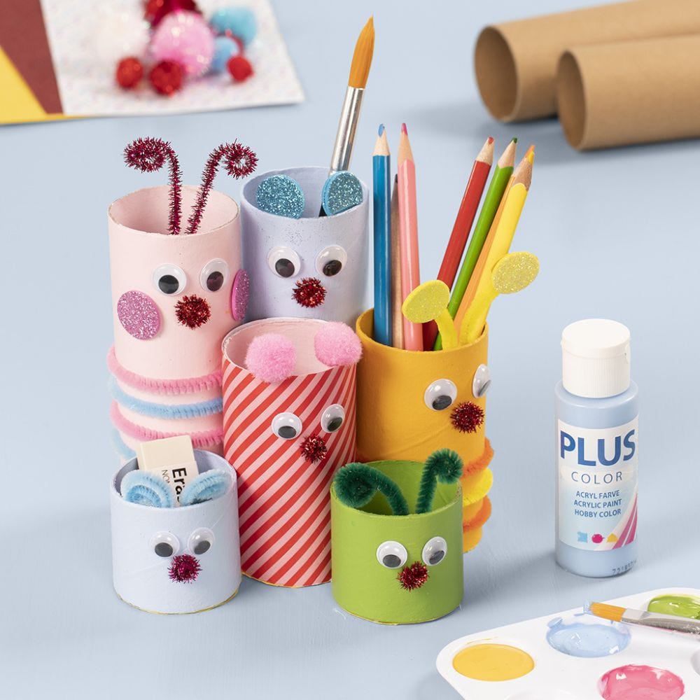 A pencil holder from cardboard tubes decorated with craft paint and basic craft materials
