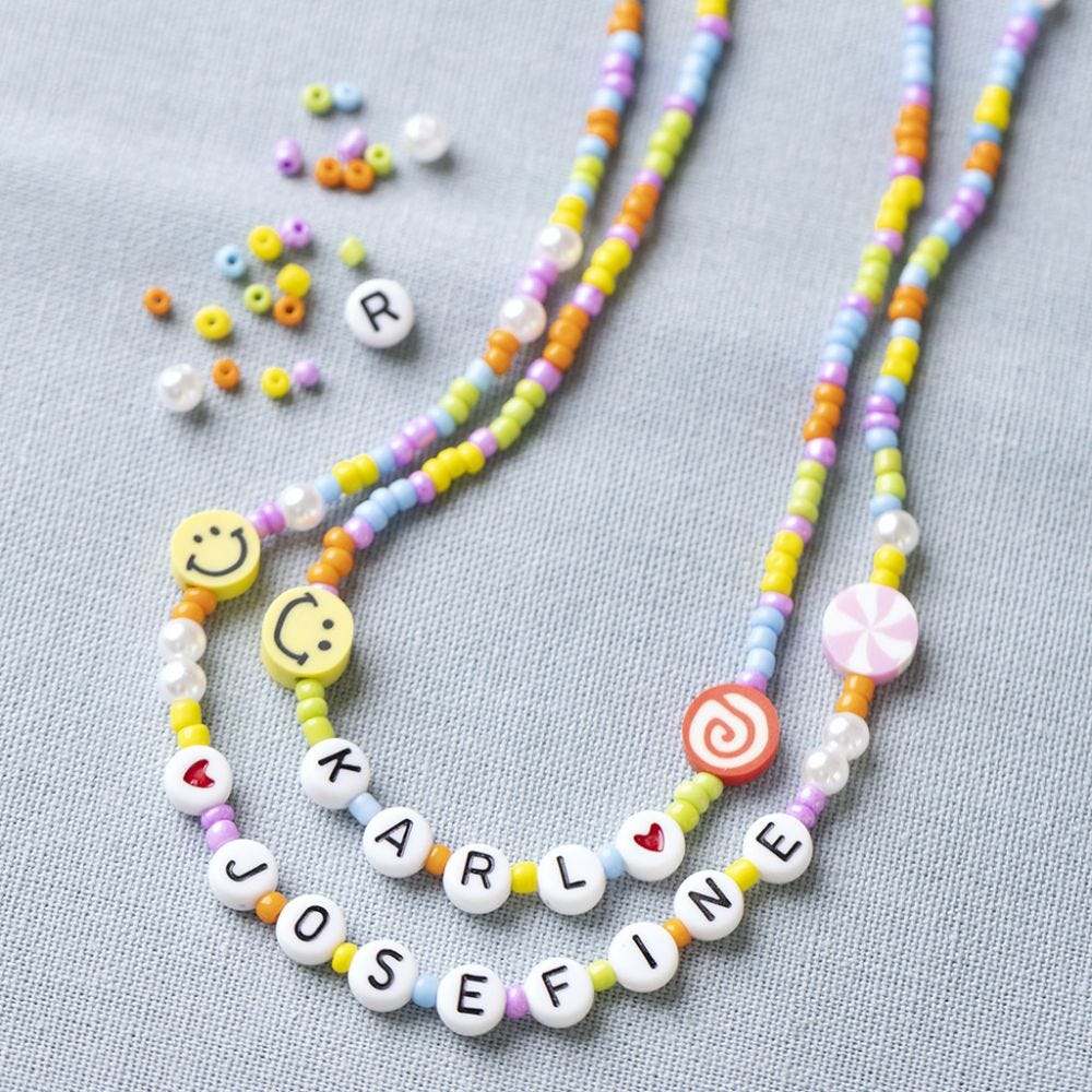 Beaded necklace with letters, figures and smileys